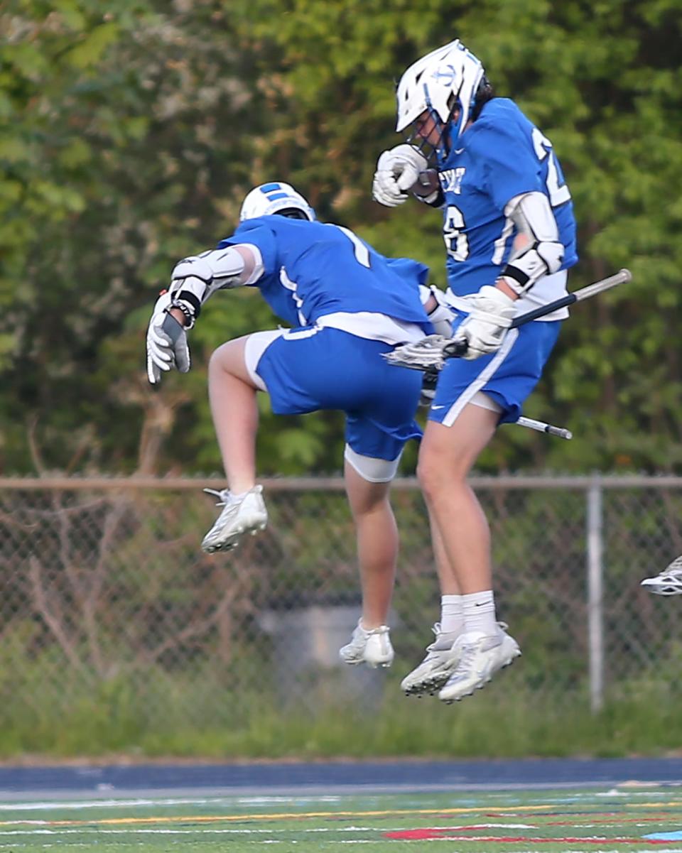 Scituate's Peter Capadona gives a chest bump to Scituate's Will Cahill whose goal cut Cohasset’s lead to 6-5 during second quarter action of their game against Cohasset at Cohasset High on Saturday, May 13, 2023. 