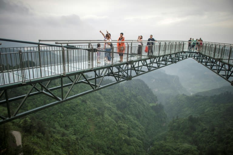 The V-shaped bridge, stretching 69.6 metres out from a single cliff-face in southwest Chongqing province, is the longest glass-bottomed skywalk of its type