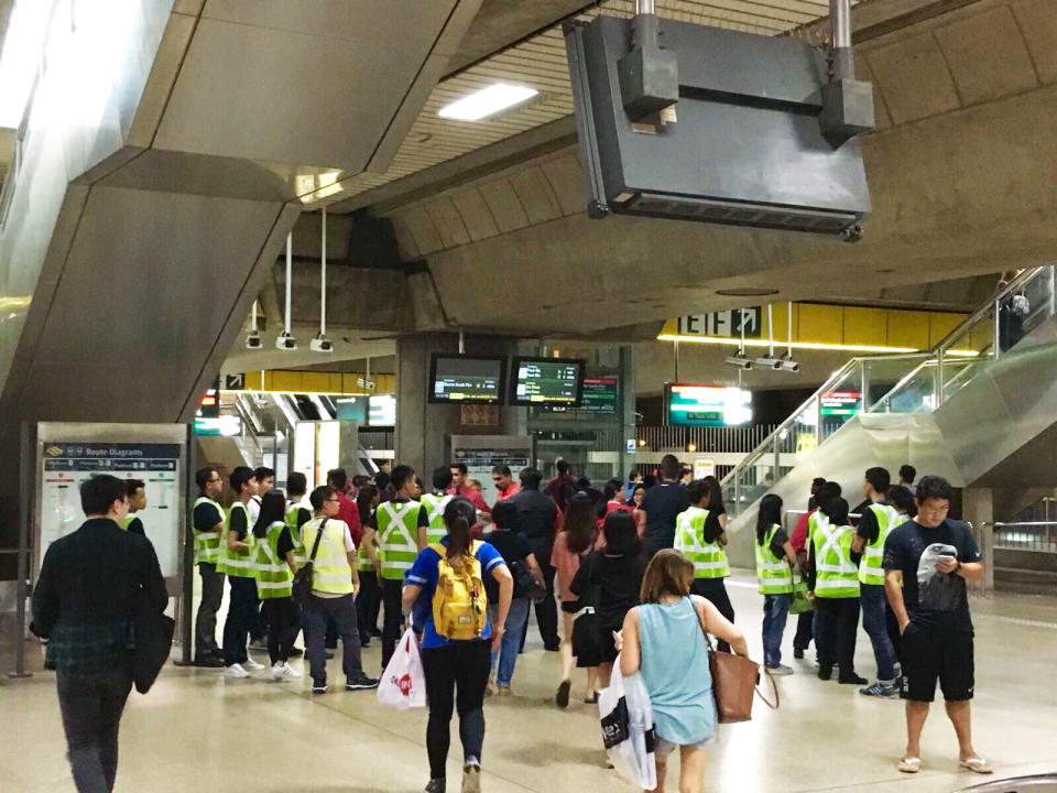Crowd marshals gather for a briefing at Jurong East Station shortly before 11pm on Friday, 8 December 2017. PHOTO: Nicholas Yong/Yahoo News Singapore