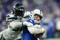 Seattle Seahawks linebacker Jordyn Brooks (56) sacks Indianapolis Colts quarterback Carson Wentz (2) during the second half of an NFL football game in Indianapolis, Sunday, Sept. 12, 2021. (AP Photo/AJ Mast)