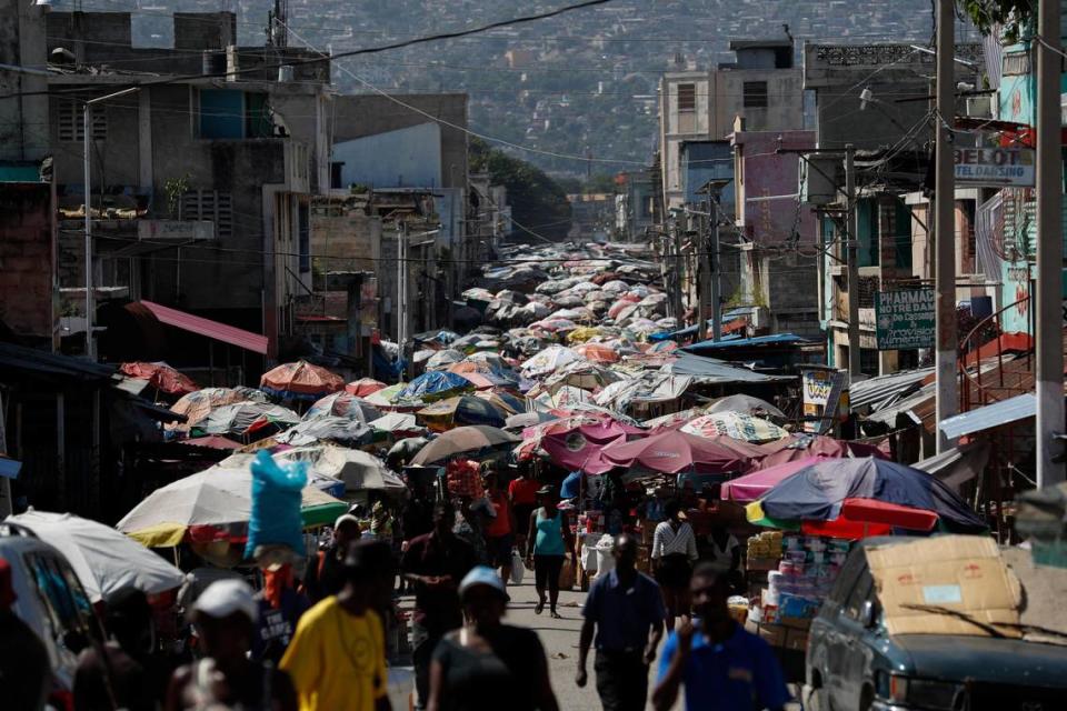 People shop in a street market during a break in anti-government protests which disrupted businesses and daily life in Port-au-Prince, Haiti, Saturday, Oct. 5, 2019.