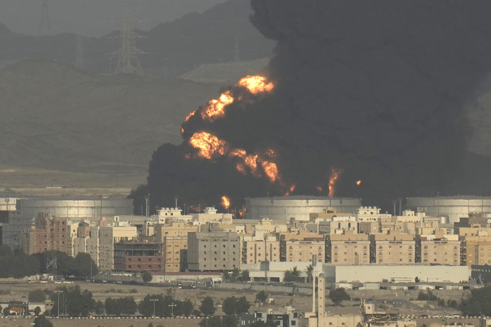 A cloud of smoke rises from a burning oil depot in Jiddah, Saudi Arabia, Friday, March 25, 2022. (AP Photo/Hassan Ammar)