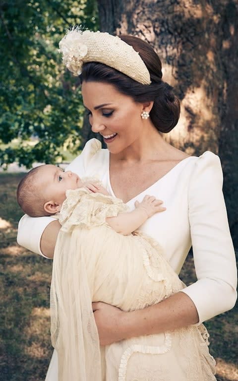 The Duchess of Cambridge holds Prince Louis in the garden at Clarence House following his christening - Credit: Matt Holyoak