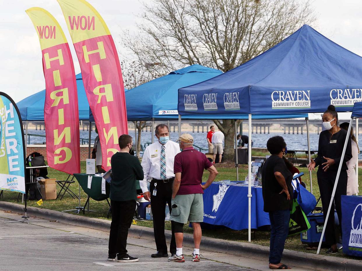 Ricky Meadows, dean of Career Programs at Craven Community College, talks about career programs with career seekers and potential students at the 6th annual Craven Works Job Fair at Union Point Park in New Bern on March 30, 2021.  [Gray Whitley / Sun Journal Staff]