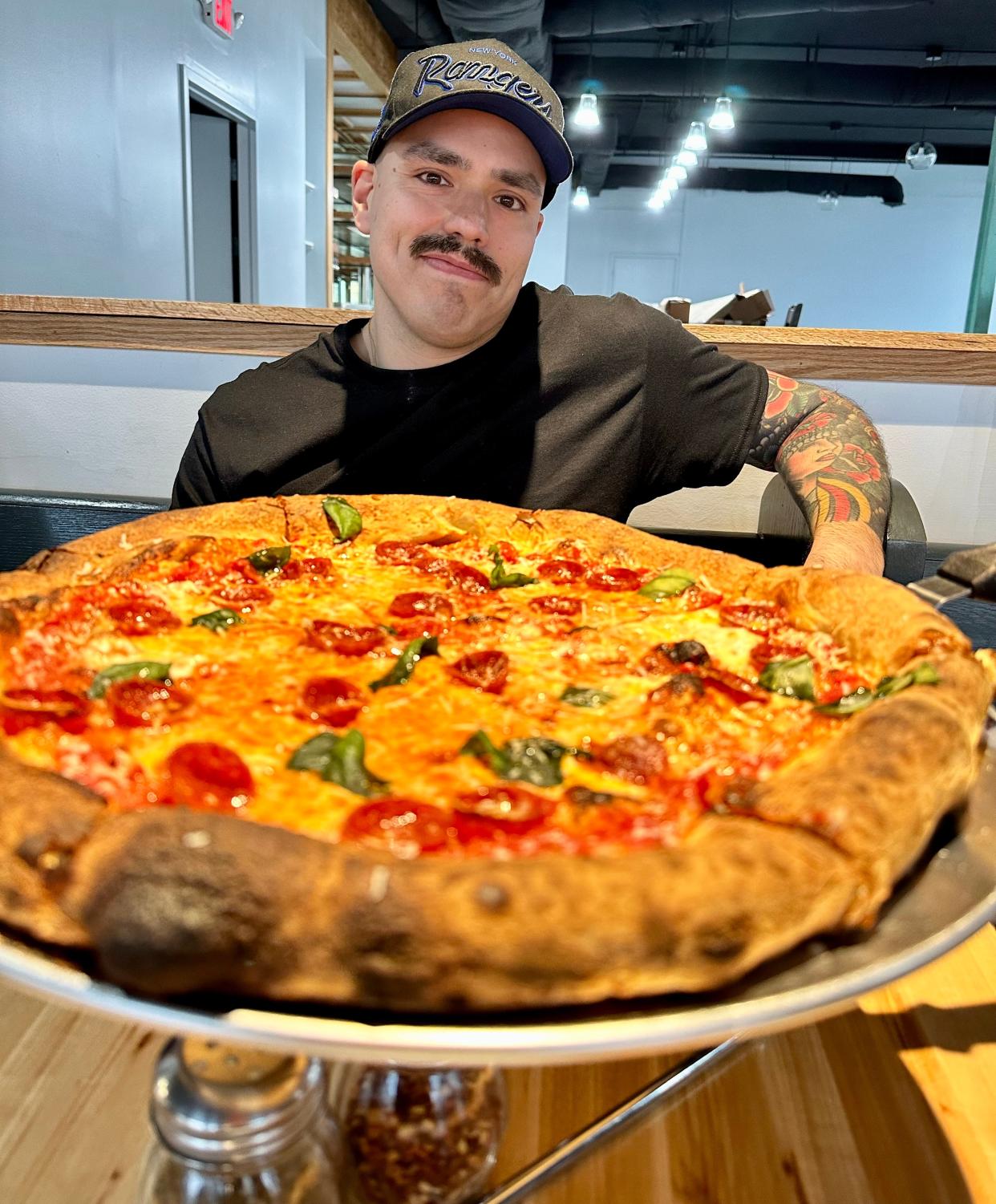 Mike Carvajal of Mike's Pizza shows off a freshly baked Il Pepe pie, which is the signature New York-style pizza now available inside Deli Ohio in Canton.