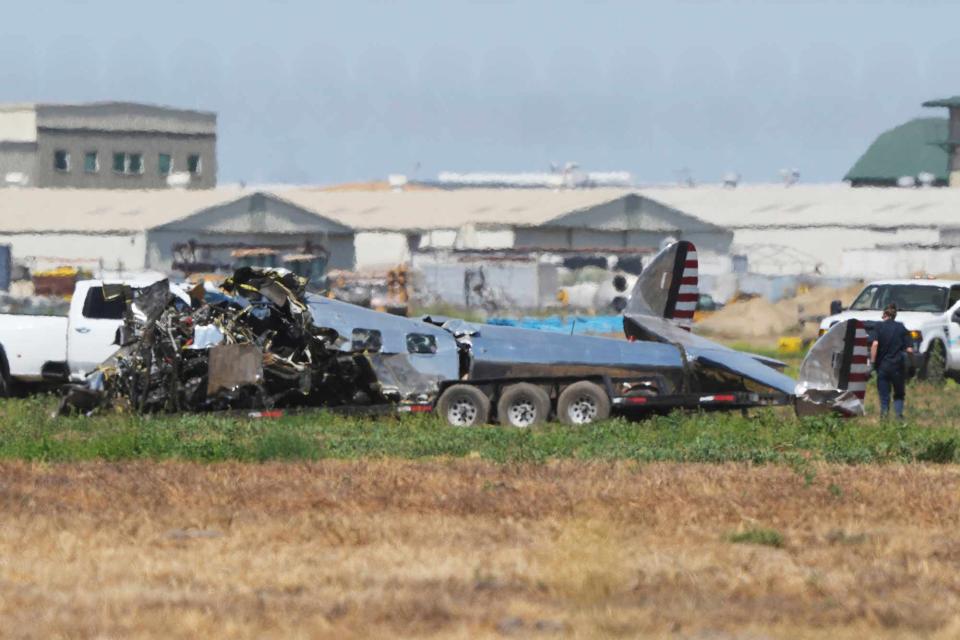 <p>Doug Benc via AP</p> A World War II-era plane crash sits in a field near the runway at Chino Airport