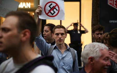 Activist holds sign during protest against U.S. President Donald Trump outside Trump Tower on Tuesday - Credit: Reuters