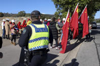 Police watch as pro China and pro Hong Kong supporters wait outside a winery where Chinese Premier Li Qiang visited in Adelaide, Australia, Sunday, June 16, 2024. (AP Photo/Kelly Barnes, Pool)