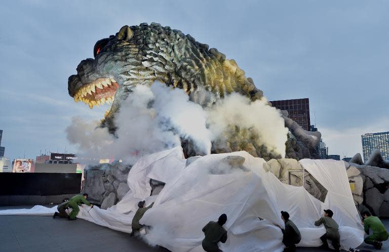 A life-size Godzilla head on a balcony of the eighth floor of Hotel Gracery Shinjuku is displayed during the official unveiling ceremony in Tokyo on April 9, 2015