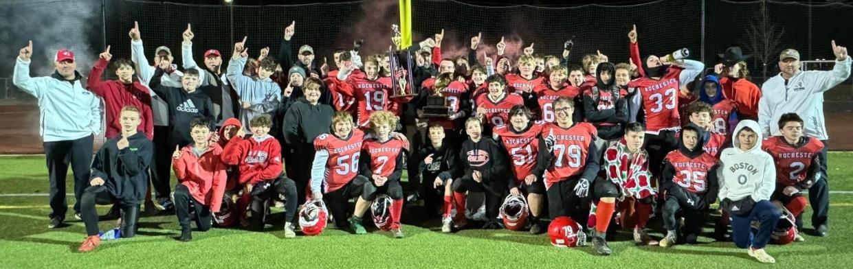 Members of the Rochester Red Raider football team celebrate after beating Andover, Massachusetts, 24-21 on Saturday in the Northeast Junior High Football League championship at Souhegan High School.