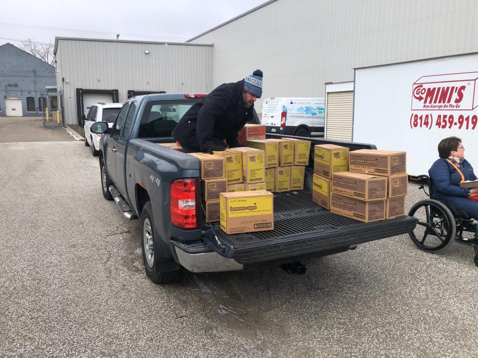 Ron Kelly loads Girl Scout cookies into his truck Feb. 24 for delivery to friends and family who've ordered them.