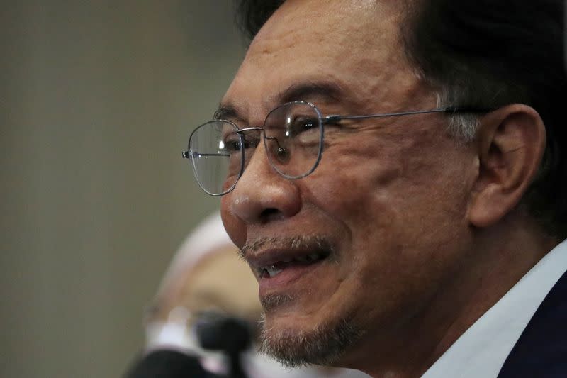 FILE PHOTO: Malaysia opposition leader Anwar Ibrahim reacts during a news conference in Kuala Lumpur