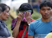 <p>Relatives of landslide victims caused by Typhoon Mangkhut, waiting near the landslide in Ucab village, Itogon town, Benguet Province, Philippines, on Sept. 17, 2018.<br>The number of people killed in the Philippines by typhoon Mangkhut rose to 40 while dozens are missing, according to provisional data gathered as emergency teams access areas struck by the storm.<br>(Photo by Francis R. Malasig, EPA) </p>