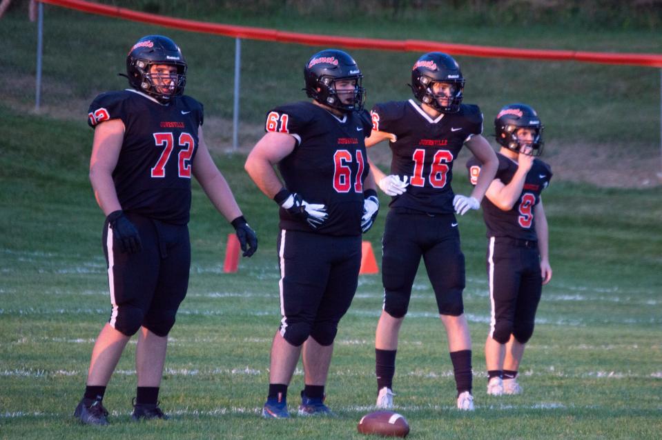 Jonesville defensive players Cooper Stevens (72), Scotty Aube (61), Fisher Potts (16) and Tyler Milks (9) will look to help the Comets earn a revenge victory over Michigan Center.