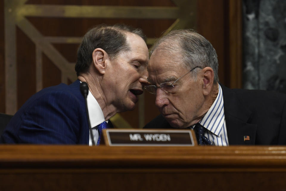 FILE - In this Tuesday, June 18, 2019, file photo, Senate Finance Committee ranking member Sen. Ron Wyden, D-Ore., left, talks with committee chairman Sen. Chuck Grassley, R-Iowa, during a hearing on Capitol Hill in Washington. A bipartisan congressional investigation released Wednesday, Dec. 16, 2020, by Grassley and Wyden, found that key players in the nation’s opioid industry have spent $65 million since 1997 funding nonprofits that advocate treating pain with medications, a strategy intended to boost the sale of prescription painkillers. (AP Photo/Susan Walsh, File)