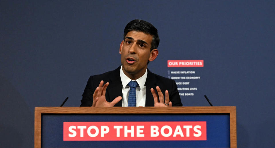 A photo of Prime Minister Rishi Sunak at a press conference with the slogan 