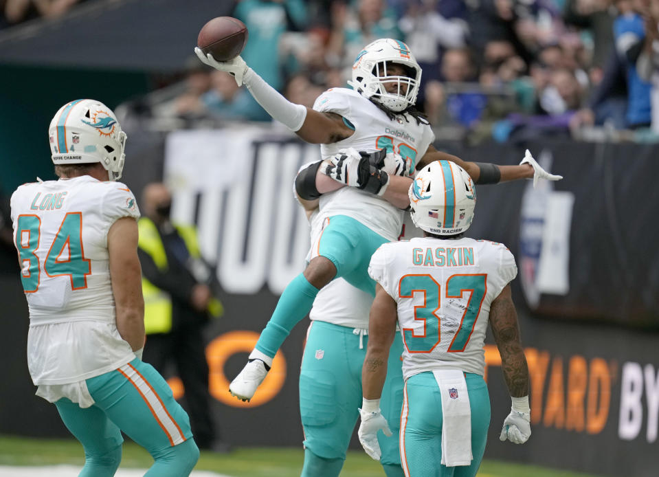 Miami Dolphins wide receiver Jaylen Waddle (17) celebrates after scoring a touchdown during the first half of an NFL football game between the Miami Dolphins and the Jacksonville Jaguars at the Tottenham Hotspur stadium in London, England, Sunday, Oct. 17, 2021. (AP Photo/Matt Dunham)