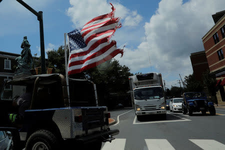 A U.S. flag flies from the back of a car, ahead the one-year anniversary of the fatal white-nationalist rally, in Charlottesville, Virginia, U.S., August 1, 2018. REUTERS/Brian Snyder