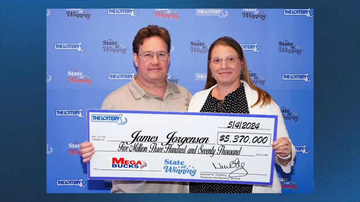 James Jorgensen and his partner, Jennifer, pose with a $5.37 million "check" that was won playing Megabucks in Northborough.