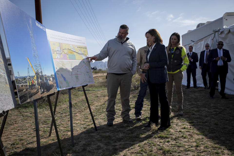 Vice President Kamala Harris, center, receives a briefing on the substantiation project from IBEW workers at the groundbreaking ceremony of the Ten West Link transmission line, Thursday, Jan. 19, 2023, in Tonopah, Ariz. (AP Photo/Alberto Mariani)