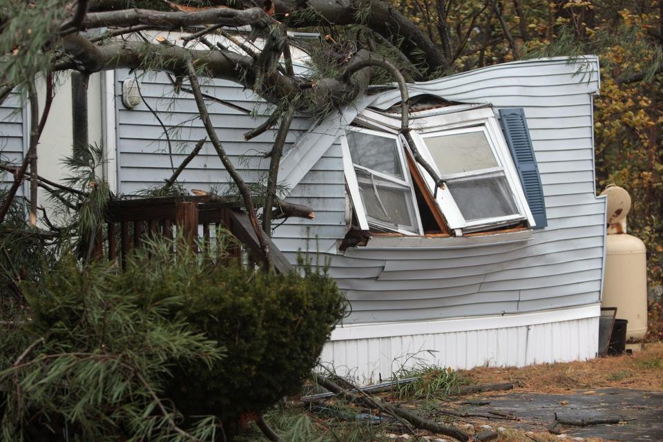 In this Oct. 29, 2012, photo, Kathy Drosos' Holbrook motor home was crushed by a falling tree during the storm in the Greater Brockton region caused by Hurricane Sandy.