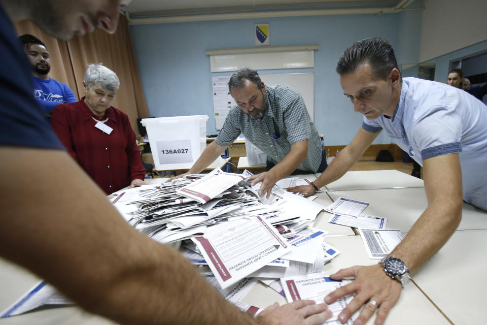 Bosnian election workers prepare to count ballots at a polling station in Sarajevo, Bosnia, on Sunday, Oct. 7, 2018. Bosnians decide in a tense election this weekend whether to cement the ethnic divisions stemming from the 1992-95 war by supporting nationalist politicians or push for changes that would pave the way toward European Union and NATO integration. (AP Photo/Amel Emric)