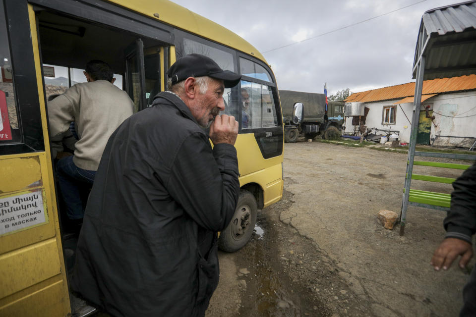 An ethnic Armenian man from Nagorno-Karabakh waits to get on a bus to Armenia's Goris, in Lissagorsk village, Azerbaijan, Sunday, Oct. 1, 2023. The last bus carrying ethnic Armenians from Nagorno-Karabakh has left the region, completing a weeklong, grueling exodus in which more than 80% of its residents have fled after Azerbaijan reclaimed the area in a lightning military operation. (AP Photo/Aziz Karimov)