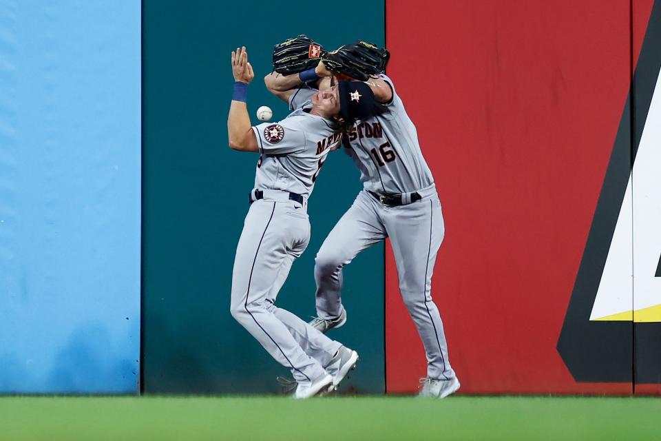 Houston Astros left fielder Aledmys Diaz, left, and center fielder Jake Meyers collide while going for a ball hit by Cleveland Guardians' Austin Hedges during the eighth inning of a baseball game Thursday, Aug. 4, 2022, in Cleveland. Hedges reached on an error by Diaz. (AP Photo/Ron Schwane)