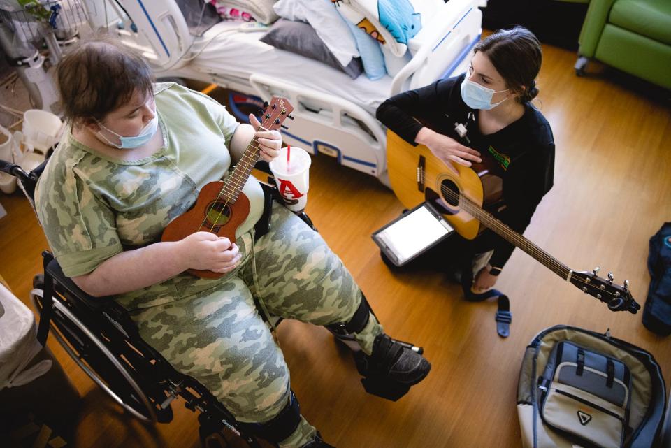 A therapist does musical therapy with Hannah Blumka at Mary Free Bed Rehabilitation Hospital in Grand Rapids. Photo provided, Mary Free Bed Rehabilitation Hospital