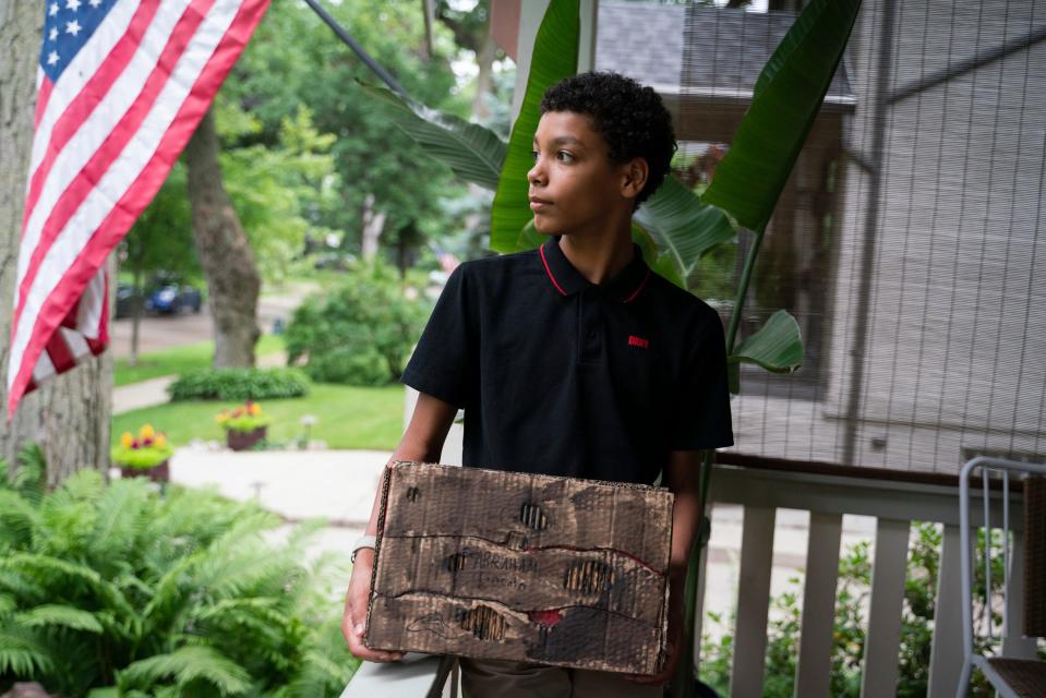 Max Maybee, 12, stands for a photo with a box from his 6th grade school project about the 16th U.S. President Abraham Lincoln at his home in Pleasant Ridge on Wednesday, July 12, 2023.