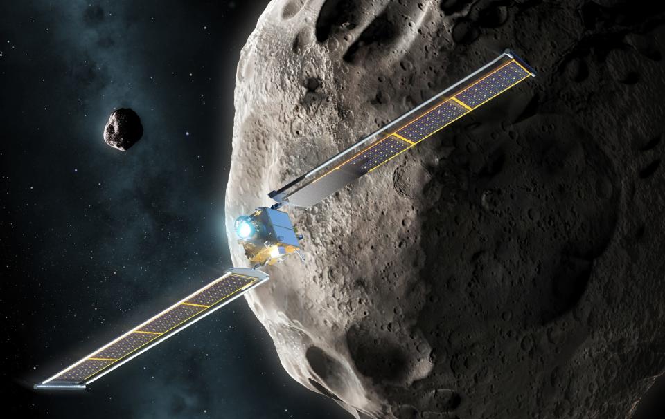 An illustration of a spacecraft flying in front of an asteroid