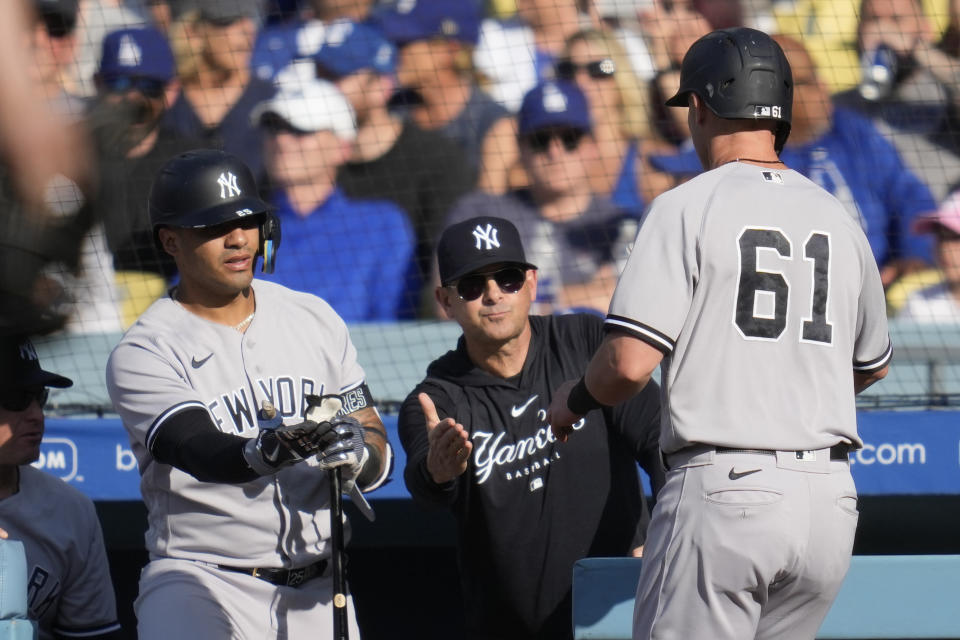 New York Yankees' Jake Bauers (61) returns to the dugout after scoring off of a ground out by Kyle Higashioka during the seventh inning of a baseball game against the Los Angeles Dodgers in Los Angeles, Sunday, June 4, 2023. (AP Photo/Ashley Landis)