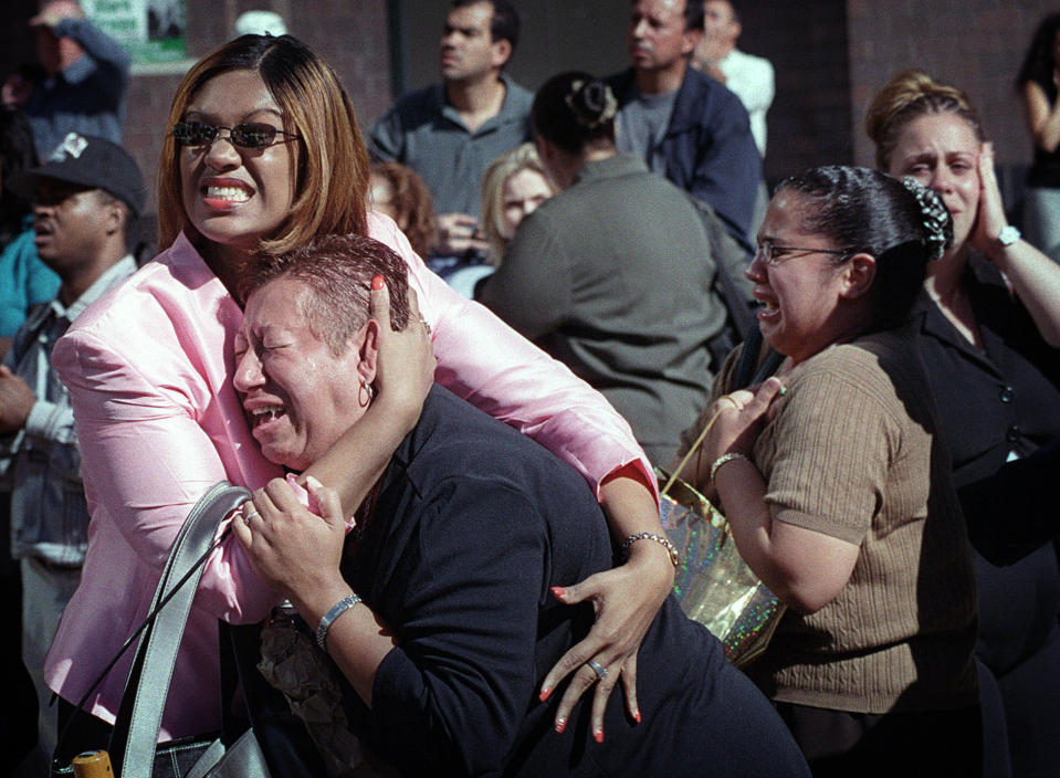 <p>Two women hold each other as they watch the World Trade Center burn in New York Tuesday, Sept. 11, 2001. (AP Photo/Ernesto Mora)</p> 