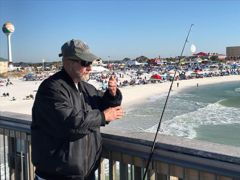 Tony Credille, of Mary Ester, passes the time fishing at the Pensacola Beach Gulf Pier as he waits for the start of the Blue Angels Homecoming Air Show on Saturday, Nov. 6, 2021.