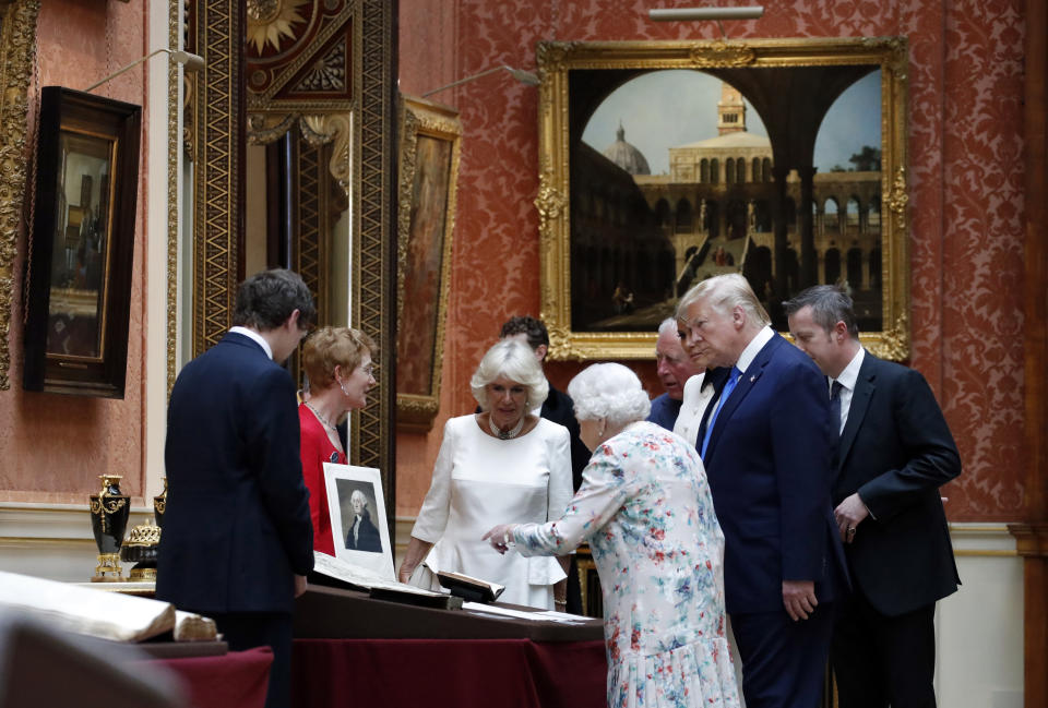 President Donald Trump, first lady Melania Trump, Queen Elizabeth II, Camilla, Duchess of Cornwall, Prince Charles and others, walk in the Picture Gallery at Buckingham Palace, Monday, June 3, 2019, in London. (AP Photo/Alex Brandon)