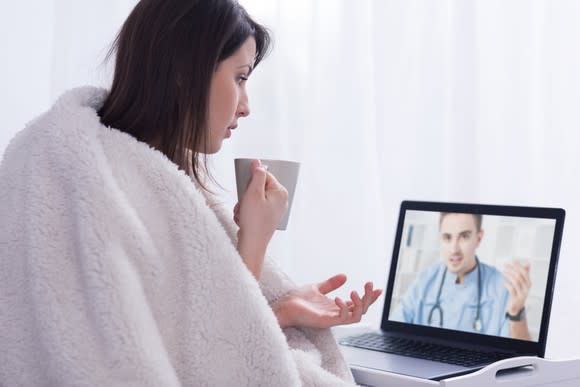 Sick woman on teleconference with doctor