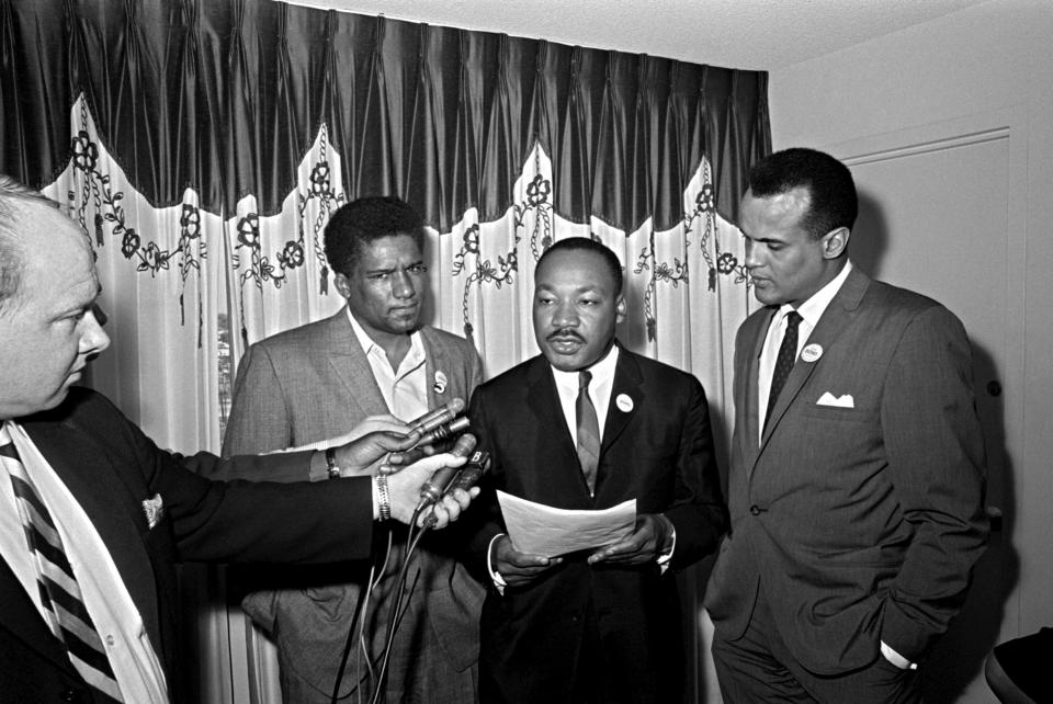 Three men standing on front voice recorders as they tell the public discontent with their organizations.