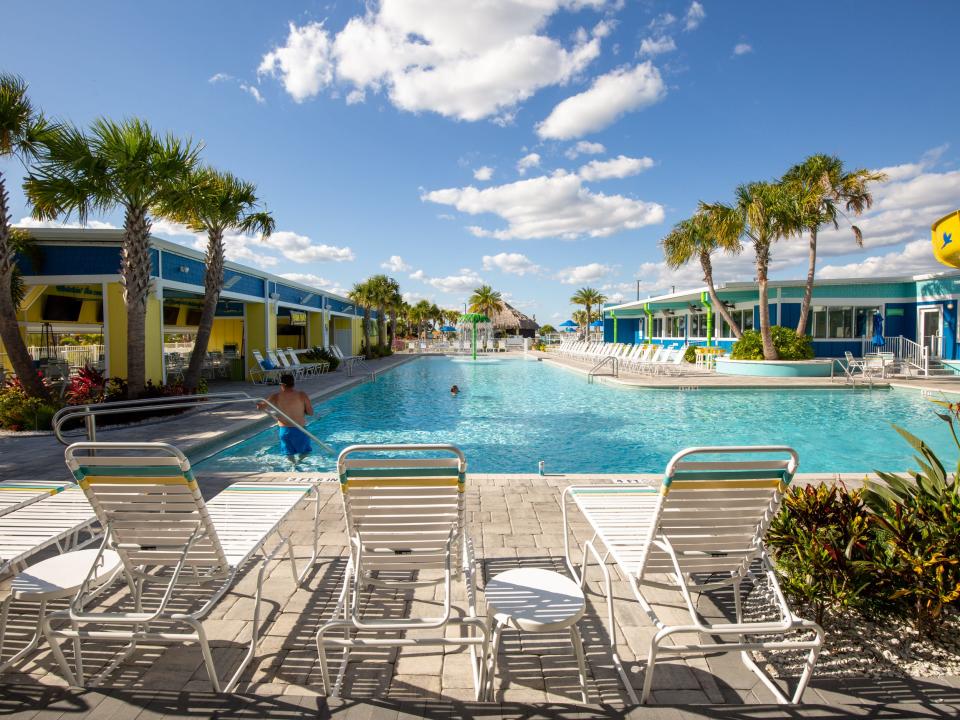 Sets of lounge chairs around a pool.