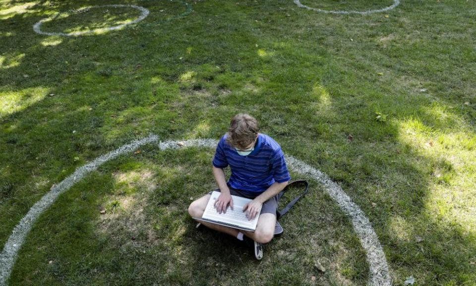 A student at Ohio State University studies on campus while observing social distancing guidelines.