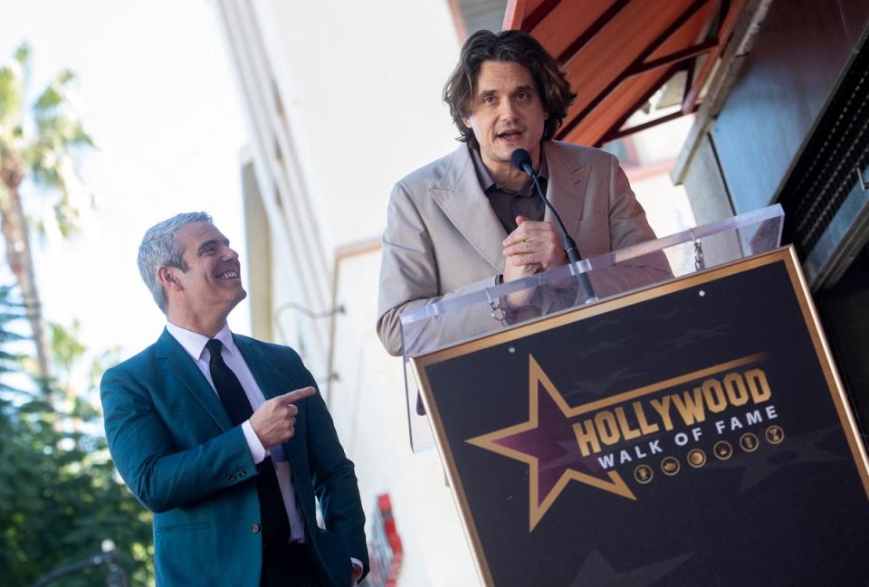 US singer-songwriter John Mayer (R) speaks onstage during the ceremony to honor Talk Show host Andy Cohen (L) with a Hollywood Walk of Fame star in Los Angeles, California, on 4 February 2022 (AFP via Getty Images)