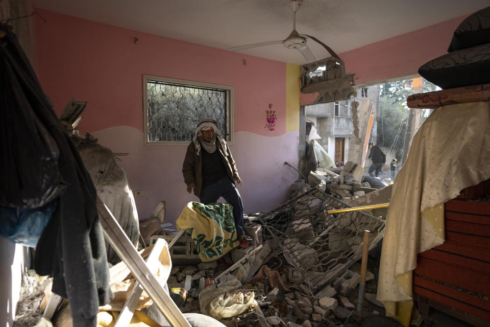 Palestinians look at their neighbour's damaged house following an Israeli strike in Rafah, southern Gaza Strip, Saturday, Jan. 27, 2024. (AP Photo/Fatima Shbair)