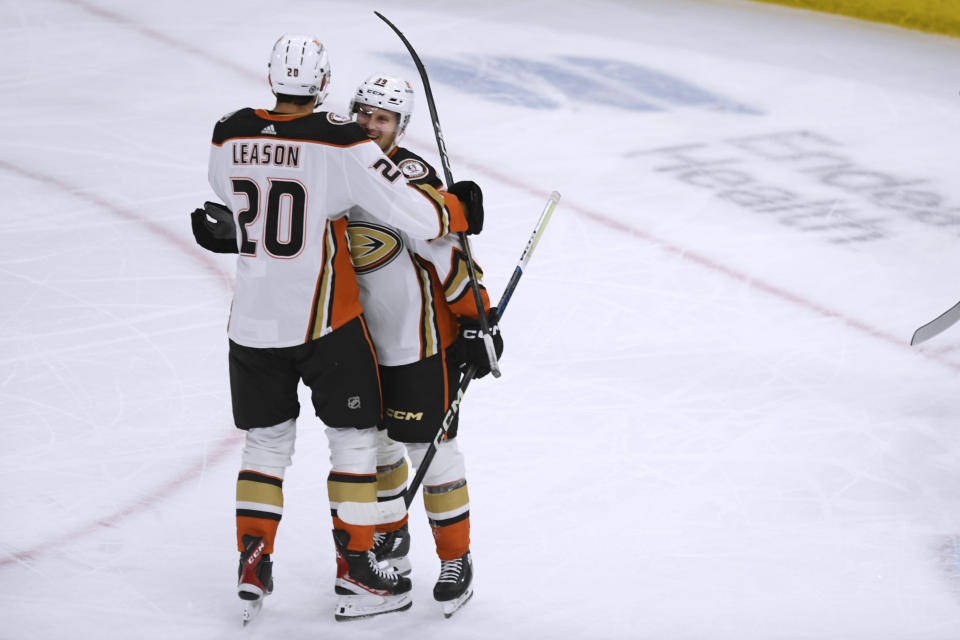 Anaheim Ducks' Brett Leason (20) celebrates with Ben Meyers (39) after scoring a goal against the Chicago Blackhawks during the first period of an NHL hockey game Tuesday, March 12, 2024, in Chicago. (AP Photo/Paul Beaty)
