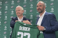 FILE - Dallas Stars NHL hockey team general manager Jim Nill, left, shakes hands with new coach Pete DeBoer during an introductory news conference in Dallas, June 22, 2022. Nill sensed things coming together for the Stars even before the season started with new coach Pete DeBoer and a roster mixed with proven veterans, up-and-coming young players and even a teenaged center. At the NHL’s All-Star break, after 51 games together, these Stars are leading the Western Conference. (AP Photo/Schuyler Dixon, file)