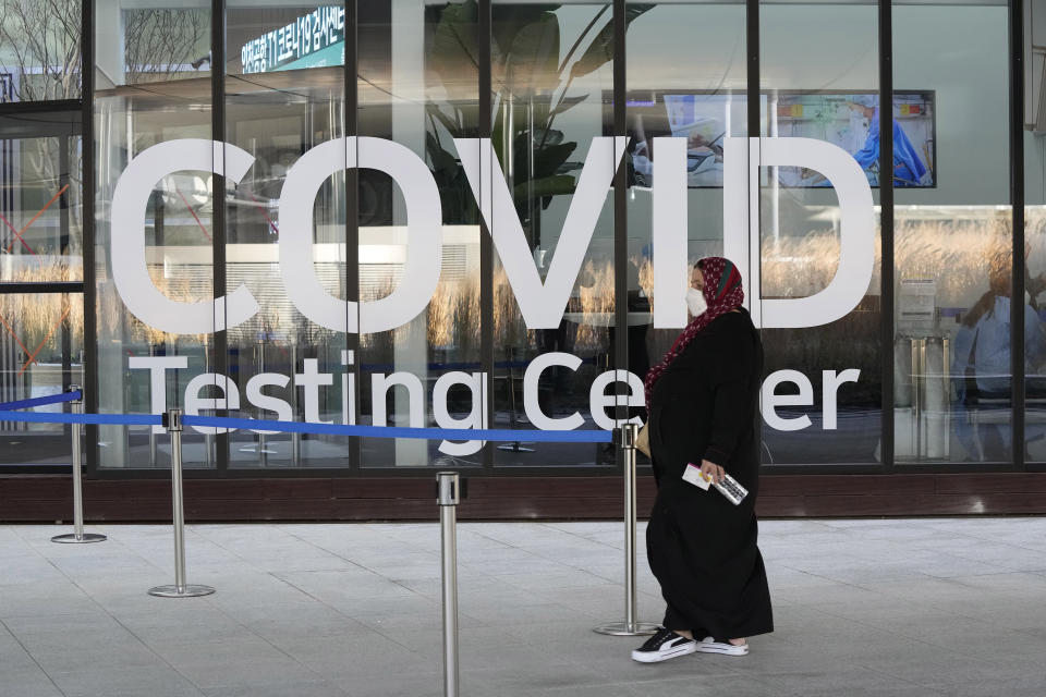 A traveler arrives to enter into a COVID-19 testing center at the Incheon International Airport In Incheon, South Korea, Wednesday, Dec. 1, 2021. South Korea's daily jump in coronavirus infections exceeded 5,000 for the first time since the start of the pandemic, as a delta-driven surge also pushed hospitalizations and deaths to record highs. (AP Photo/Ahn Young-joon)