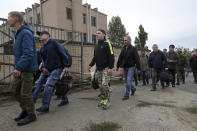 FILE - Russian recruits walk past a military recruitment center in Volgograd, Russia, Saturday, Sept. 24, 2022. Russian President Vladimir Putin on Wednesday ordered a partial mobilization of reservists to beef up his forces in Ukraine. (AP Photo, File)