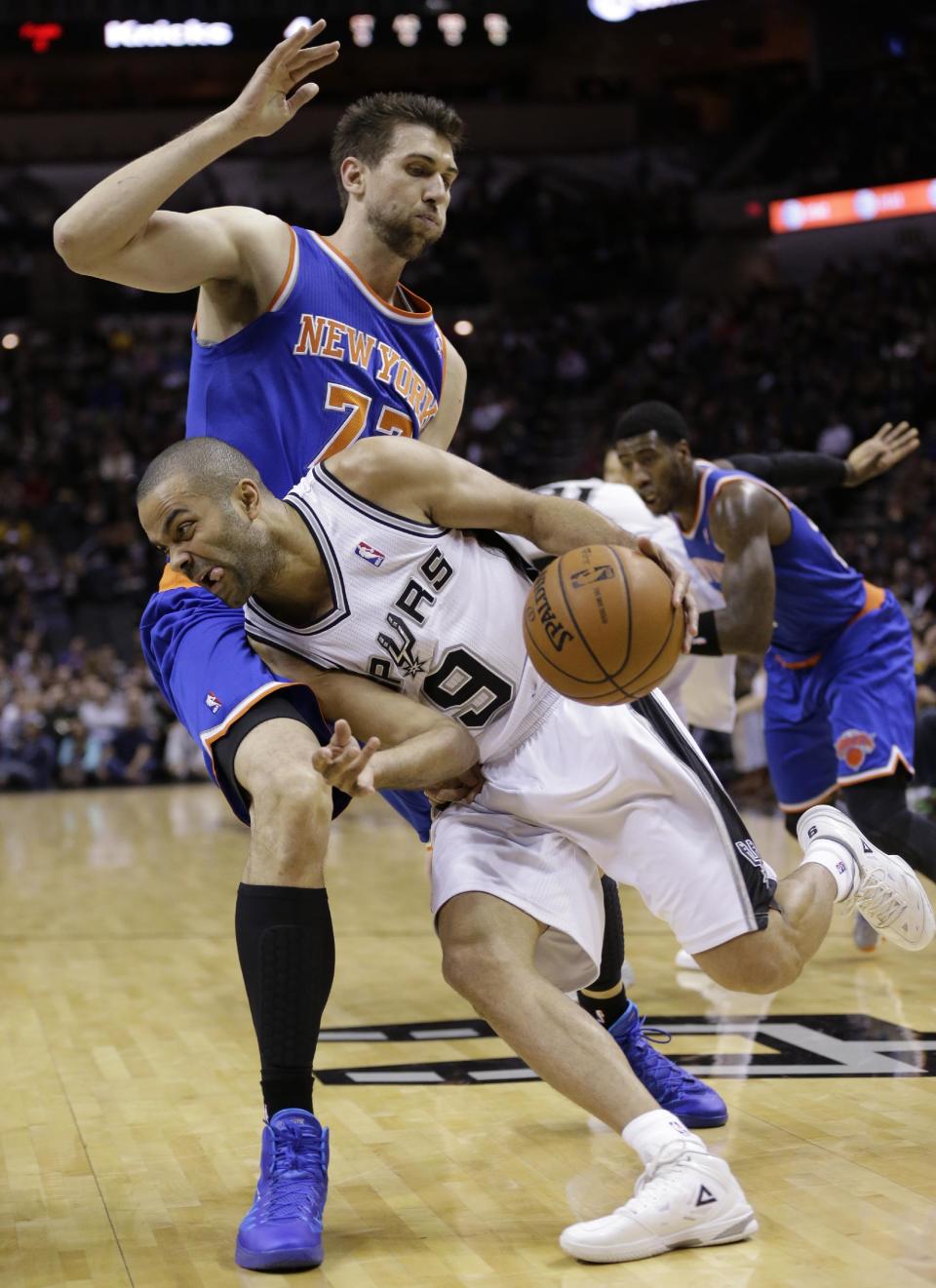 San Antonio Spurs' Tony Parker (9) drives around New York Knicks' Andrea Bargnani during the first half on an NBA basketball game, Thursday, Jan. 2, 2014, in San Antonio. (AP Photo/Eric Gay)