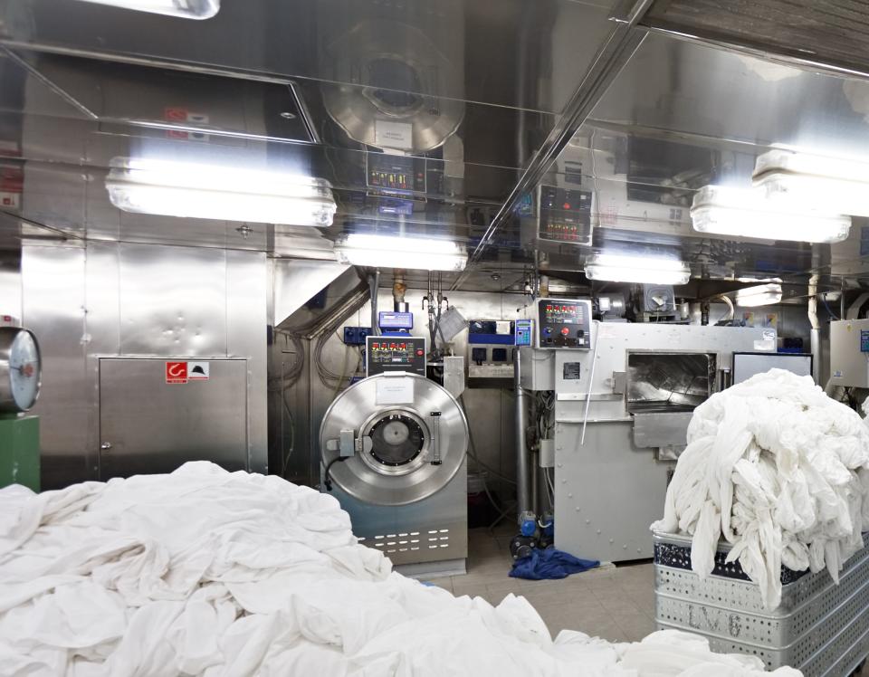 Piles of sheets in a hotel laundry room