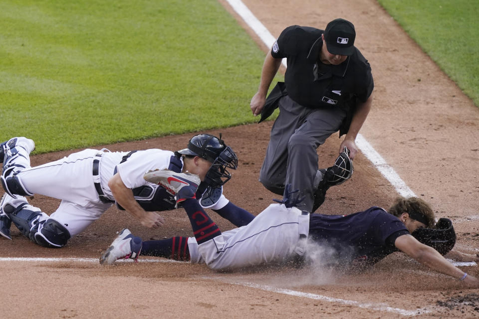 Cleveland Indians' Josh Naylor is tagged out at home by Detroit Tigers catcher Jake Rogers as home plate umpire Lance Barrett watches during the second inning of a baseball game, Wednesday, May 26, 2021, in Detroit. Naylor was trying to score from first base on teammate Owen Miller's double to deep center. (AP Photo/Carlos Osorio)