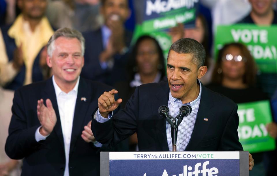 FILE - In this Nov. 3, 2013, file photo, President Barack Obama, right, as he speaks at a campaign rally with supporters for Virginia Democratic gubernatorial candidate Terry McAuliffe, left, at Washington Lee High School in Arlington, Va. Former President Obama will campaign with McAuliffe in the final stretch of the Virginia governor's race. McAuliffe's campaign announced that Obama will join him in Richmond on Oct. 23, 2021, to mobilize Virginians during early voting, which began weeks ago.   AP Photo/Cliff Owen, File) ORG XMIT: RIC501