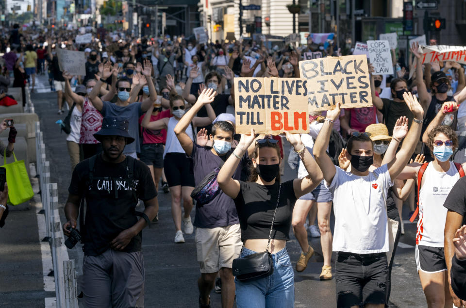 Activists move along Seventh Avenue, Saturday, June 6, 2020, in New York, during a protest over the death of George Floyd, who died May 25 after being restrained by police in Minneapolis. (AP Photo/Craig Ruttle)